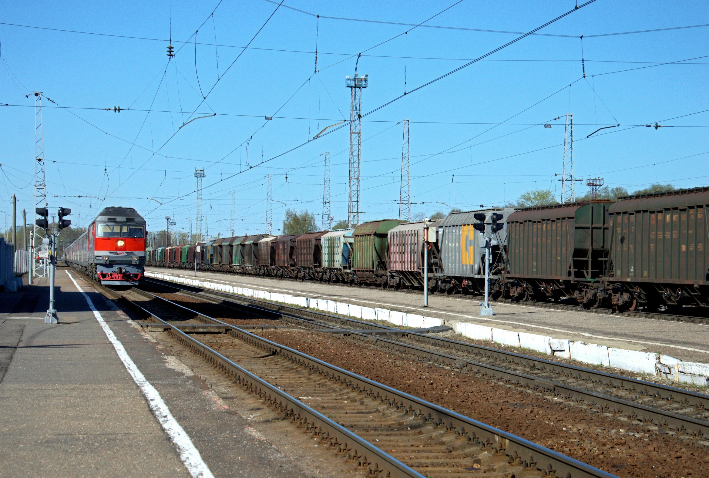 a train traveling down train tracks next to a train station, a picture, square, shipping containers, russian, wenjr