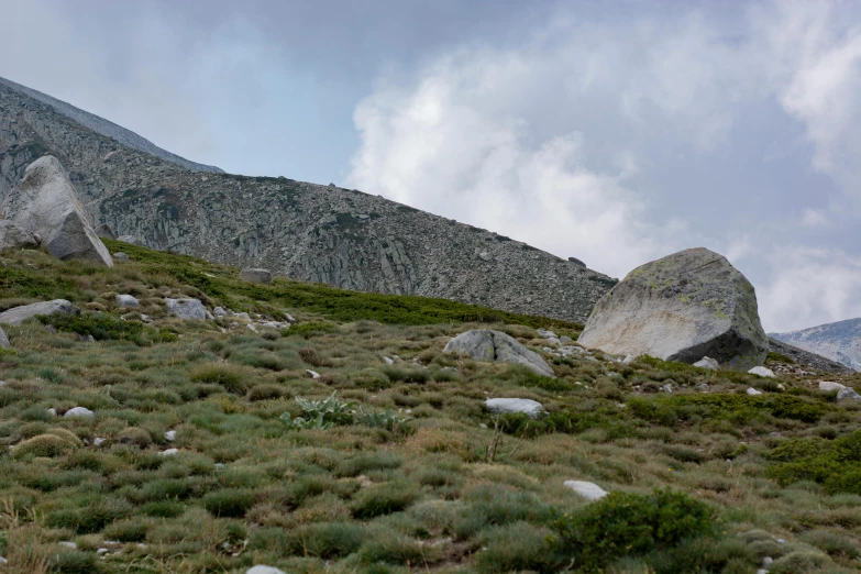 a couple of large rocks are shown on the hill