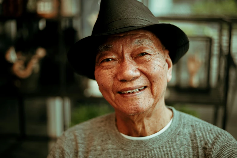 a close up of a person wearing a hat, pexels contest winner, mingei, asian old skinny scientist, smiling male, grandfatherly, youtube thumbnail