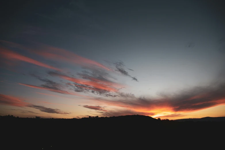 a sunset with clouds and mountains in the background, a picture, unsplash contest winner, minimalism, sky night, low quality photo, various posed, 1 2 9 7