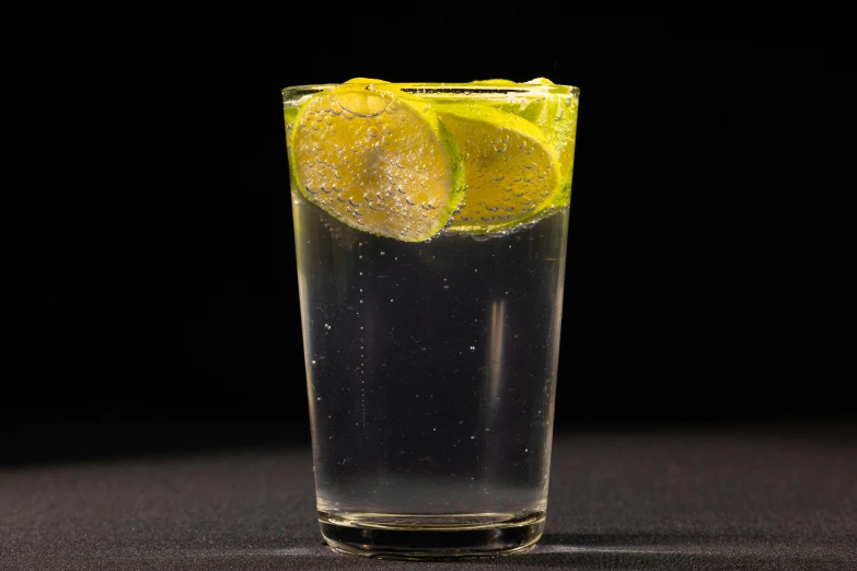 a glass of water with a slice of lemon in it, pexels, photorealism, with a black background, mule, three quarter angle, sprite