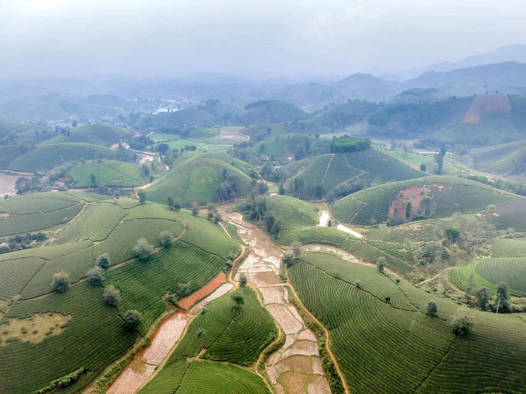 a po taken from above of a river in the middle of a mountain valley