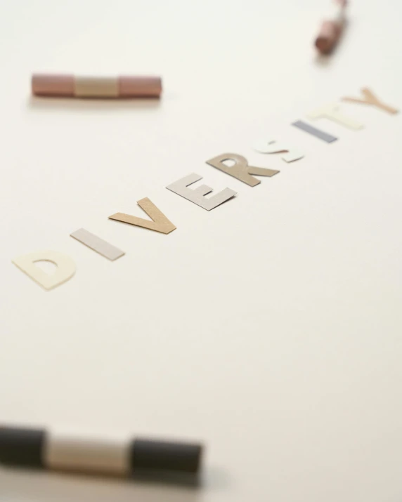 a pen laying on top of a piece of paper, by Arabella Rankin, letterism, gold and silver shapes, diversity, paintchips, instagram story