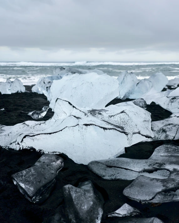 an iceberg on the beach near some rocks