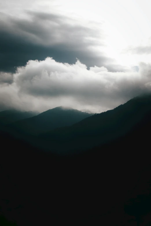 this is a black and white image of the sky and some mountains