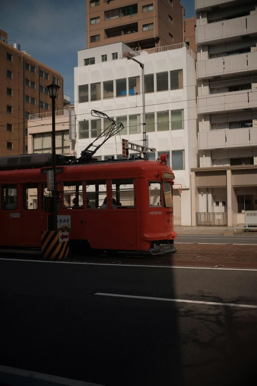 an old trolley car on a street in front of some large buildings