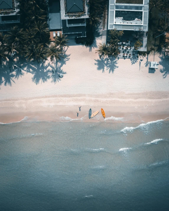 a small group of people on the beach with a para - sail