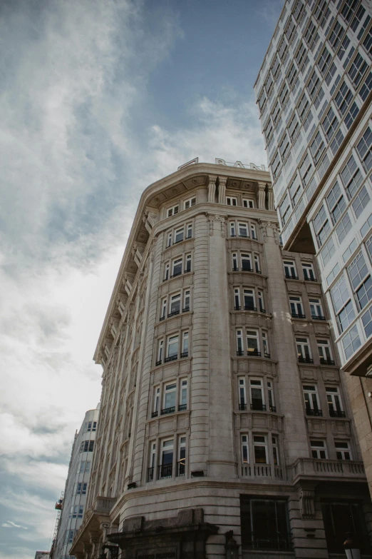 a very tall building sitting in the middle of a city, unsplash, art nouveau, concrete building, low quality photo, wellington, wideangle