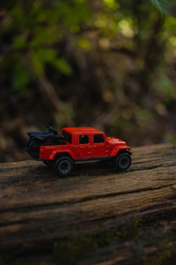 a toy truck parked on a tree stump