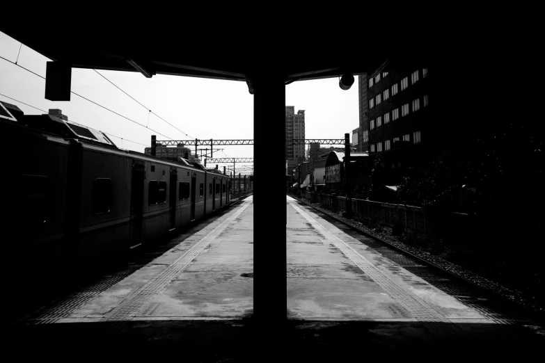 a black and white photo of a train at a train station, postminimalism, tokyo - esque town, esthetic photo, gopro photo, silhouette!!!