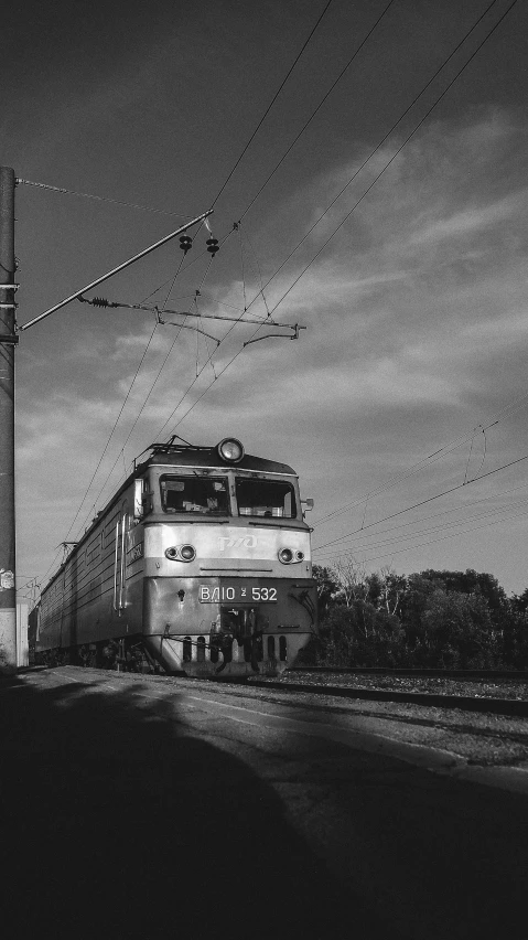 a black and white photo of a train on the tracks, by Ihor Podolchak, nostalgic 8k, high quality photo, electric, rostov