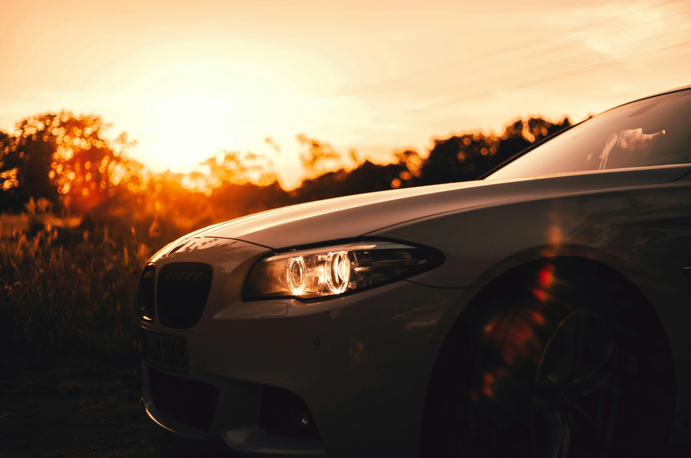 a car is parked with the sun in the background