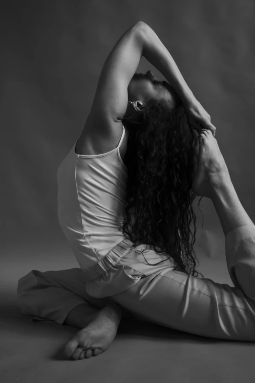 a woman with long hair is sitting on the floor