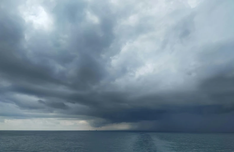 a boat is out in the water on a cloudy day