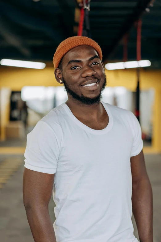 a man in a white t - shirt smiles