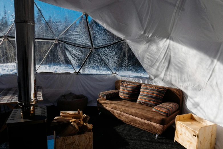 a living room filled with furniture and a large window, inspired by Buckminster Fuller, unsplash contest winner, in an igloo, cold environment, glamping, “diamonds