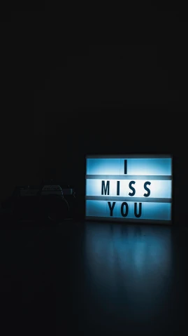 a light up sign that says miss you, a cartoon, inspired by Elsa Bleda, pexels, minimalism, vhs, set photo, miscellaneous objects, stock photograph