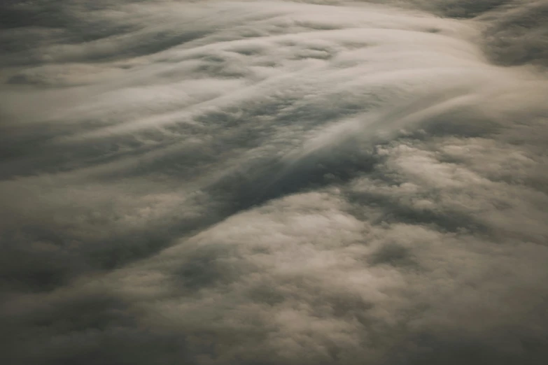 clouds rolling in to the side of a large plane