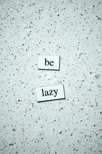two pieces of paper with the words be lazy written on them, unsplash, happening, magnetic, terrazzo, relaxed dwarf with white hair, inspirational
