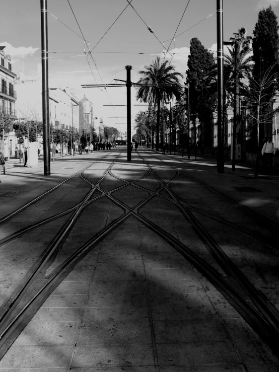 black and white pograph of a street and train tracks