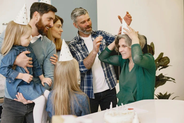 a group of people standing around a birthday cake, pexels contest winner, aging, over the shoulder, practical effects, families playing