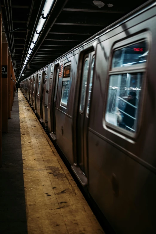 the subway is parked next to the doors