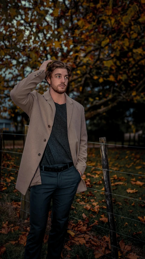 a man standing in a field near leaves