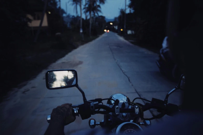a person is taking a picture with their motorcycle mirror