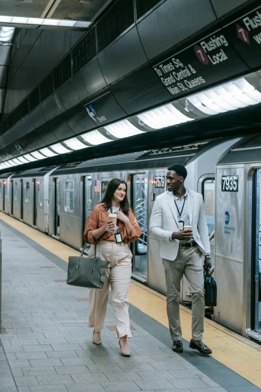 a couple of people that are standing next to a train, in new york city, talking, top selection on unsplash, subways