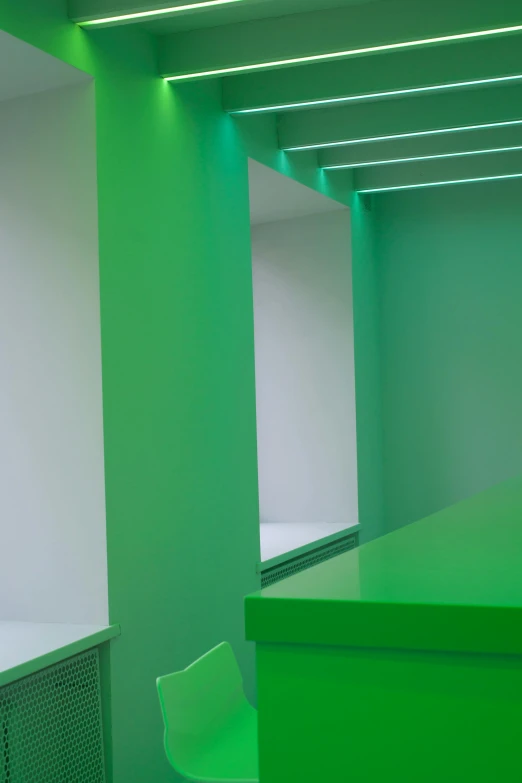 a green counter and some chairs in a room, inspired by Donald Judd, unsplash, conceptual art, volumetric rainbow lighting, detail shot, 3/4 view from below, green and white