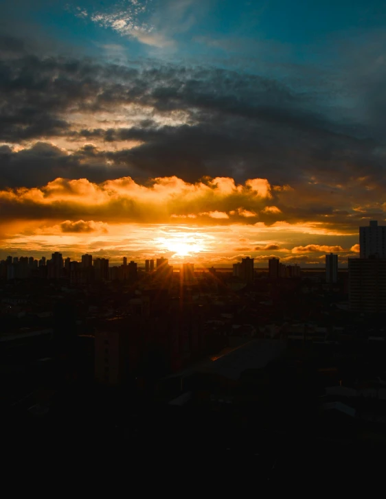 a view of the sun setting over a city, by Robbie Trevino, on a cloudy day, manila, fan favorite, high quality image