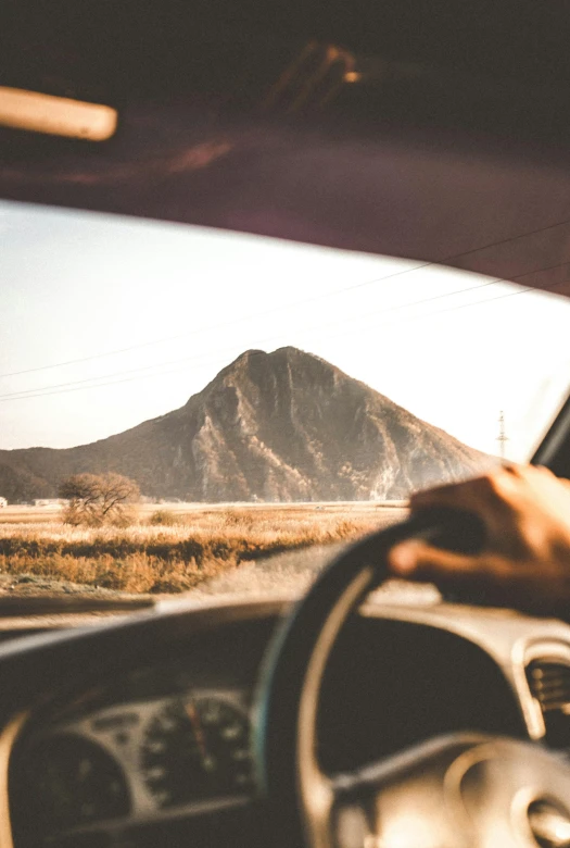 the view from inside a car driving in to desert