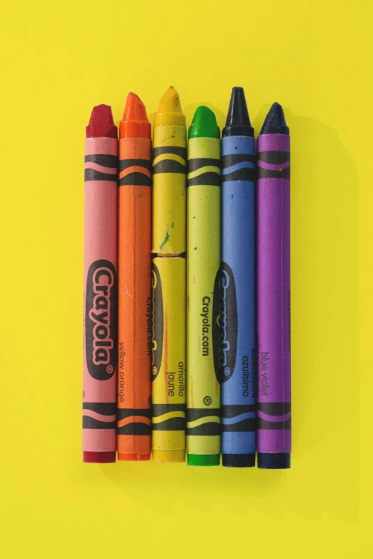 a row of crayons on a yellow background, inspired by Craola, 256 colors, photorealist, 6 colors, stacked image