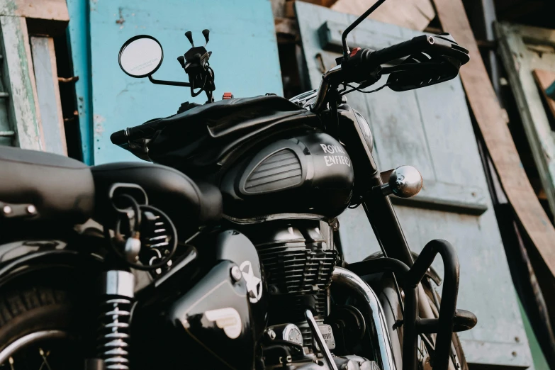 a close up of a motorcycle parked in front of a building, pexels contest winner, hindu, matte black, avatar image, classic gem