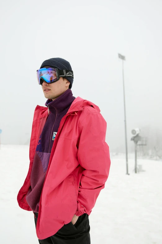 the man is standing in snow gear on the mountain