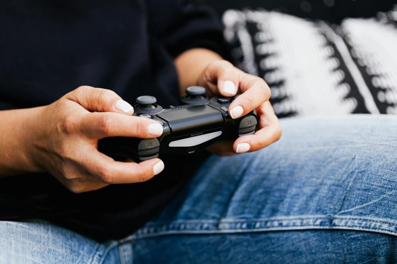 person sitting down holding a wii remote