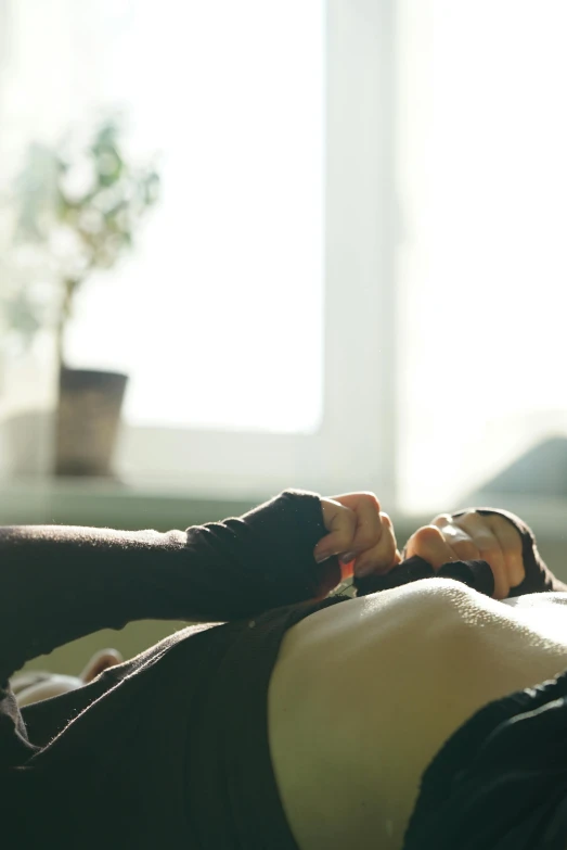 a women in black shirt laying down on the couch