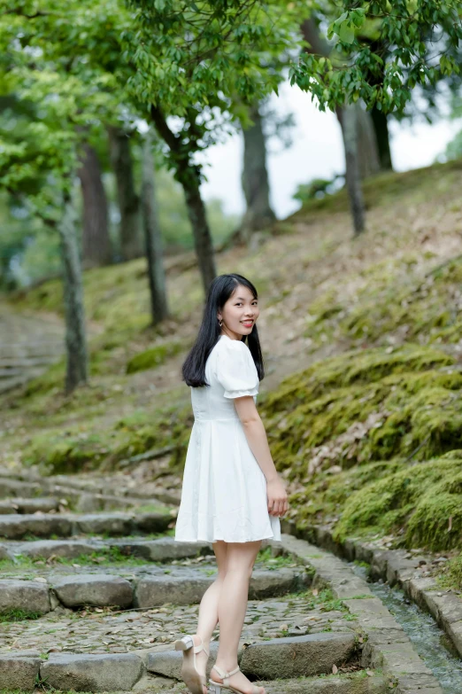 a young lady with a nice dress poses for a po