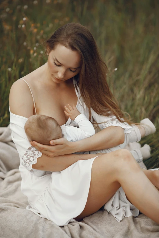 a woman holding a baby in her lap