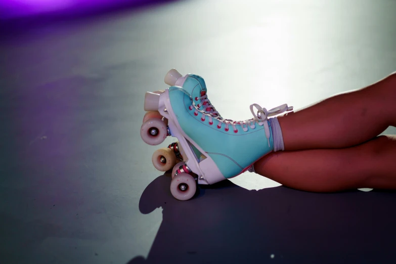 a child's feet in blue roller skate shoes