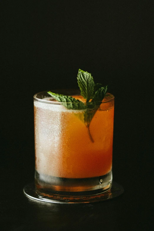 a close up of a tall glass with orange