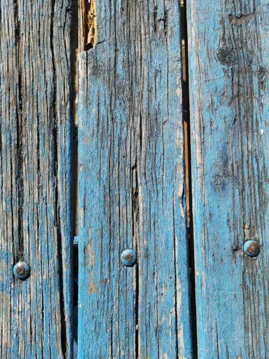 blue painted wooden planks with peeling paint