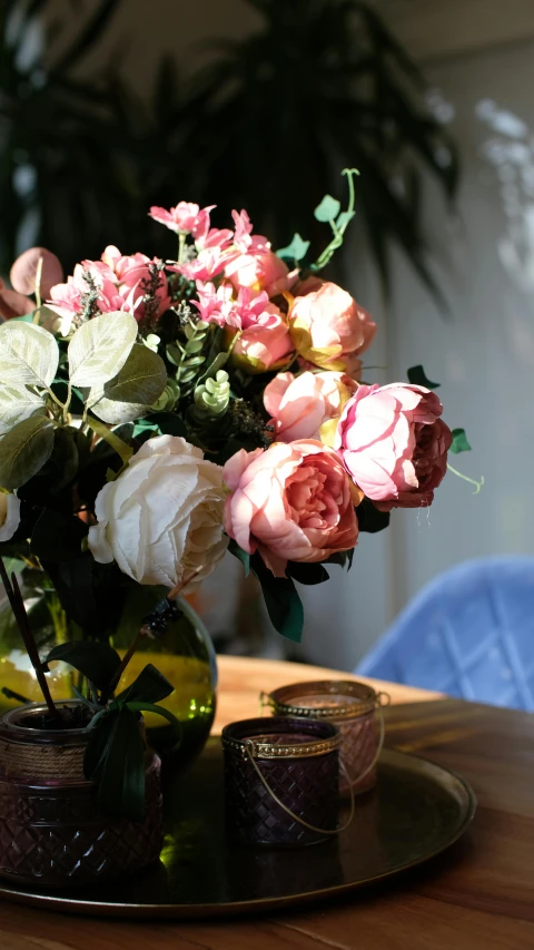 a table topped with a vase filled with flowers