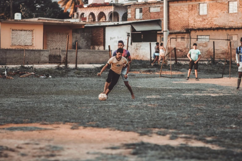 a group of men playing soccer in an open area