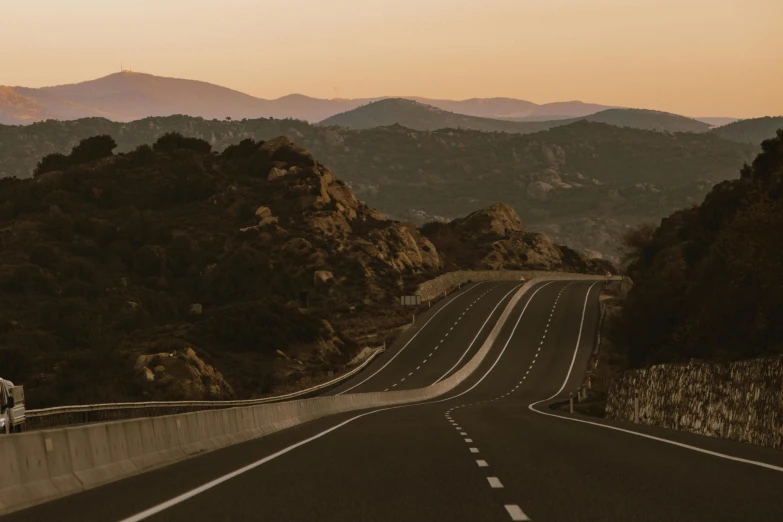 a road is passing by a mountain range