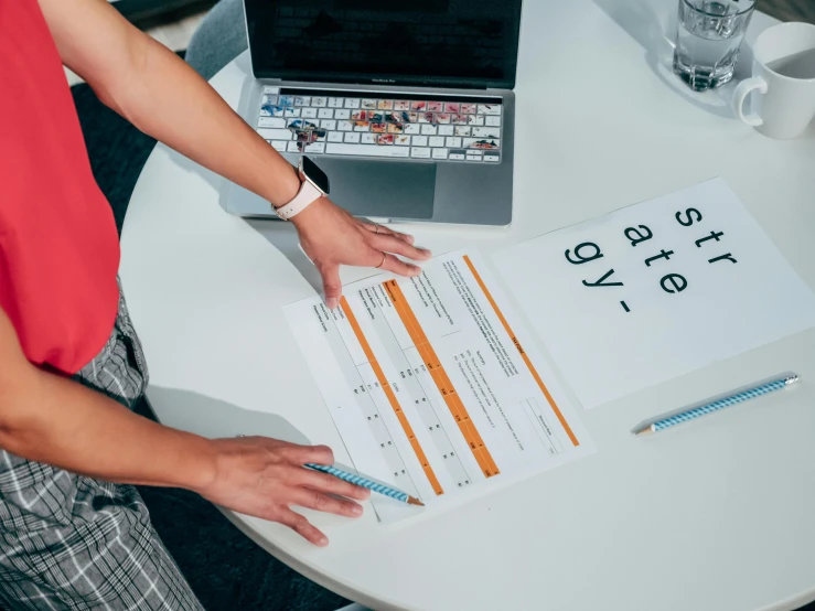 a person at a table holding a piece of paper