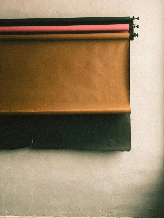 a red and black book hanging up against the wall