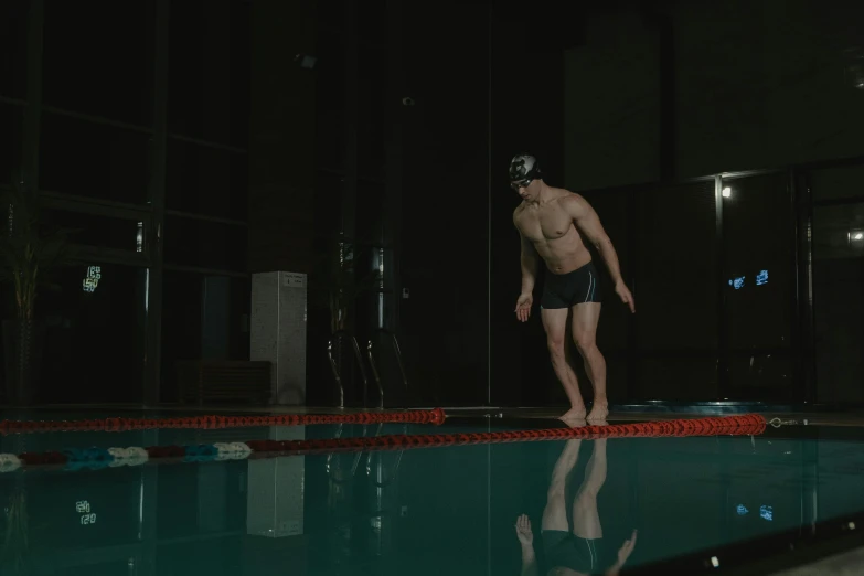 a man standing in the middle of a swimming pool