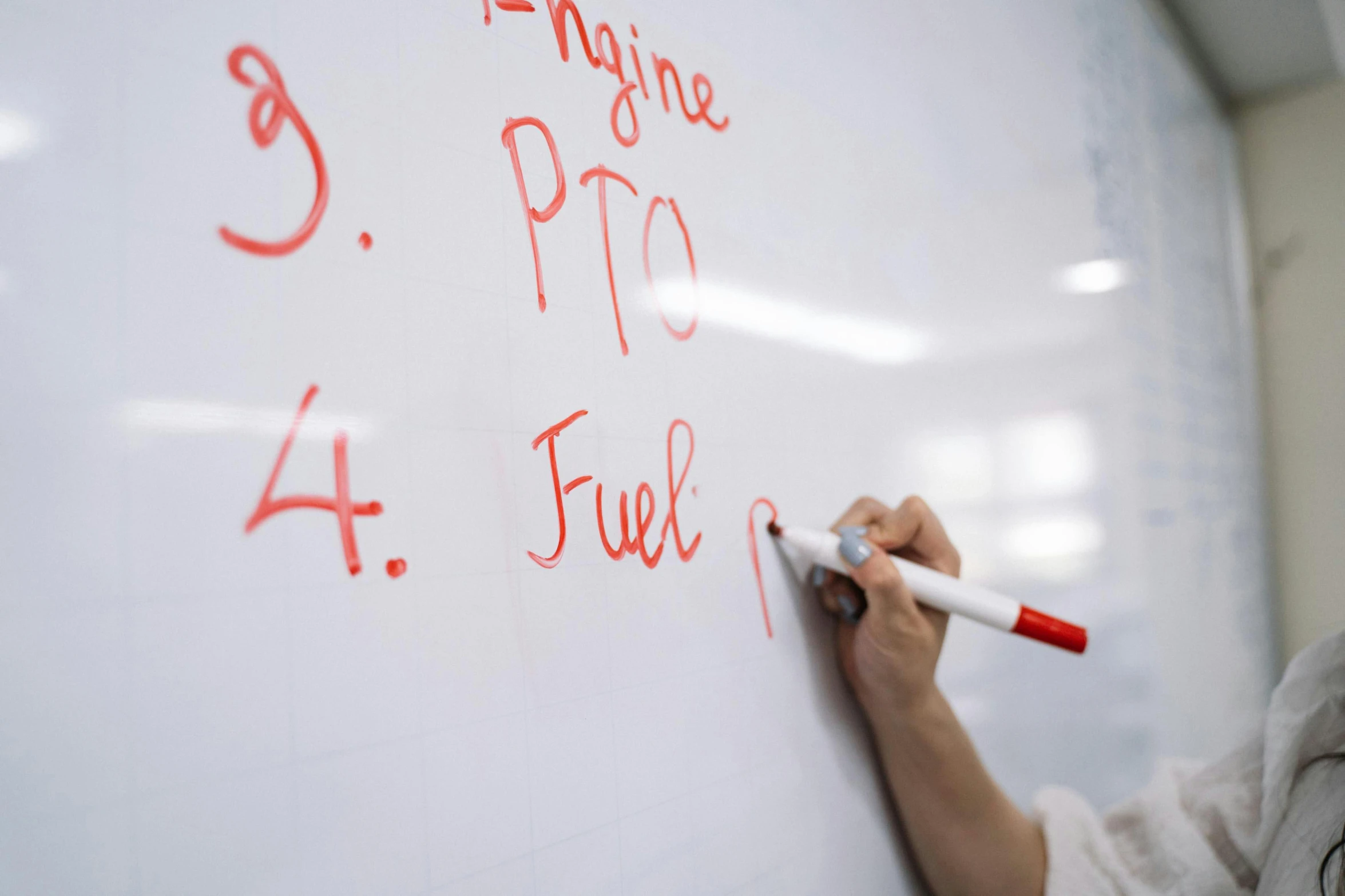 someone drawing on the wall with a whiteboard