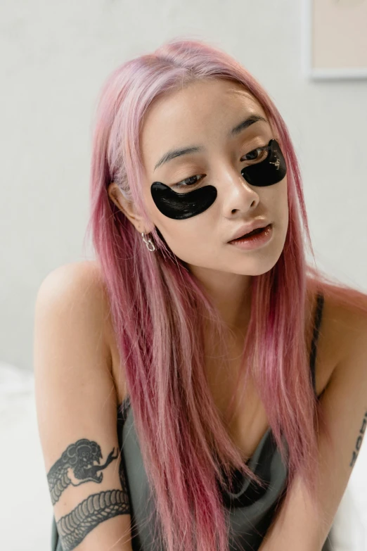 a girl with black and pink hair and blindfold